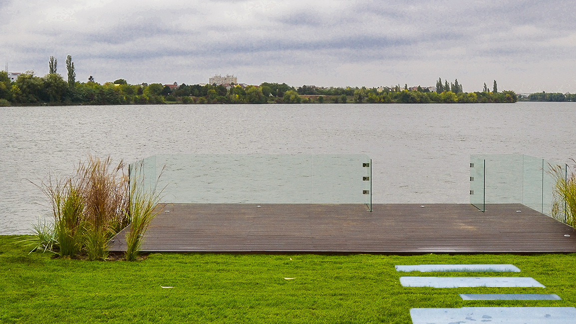 Glass railings and reflective surfaces in a contemporary landscape