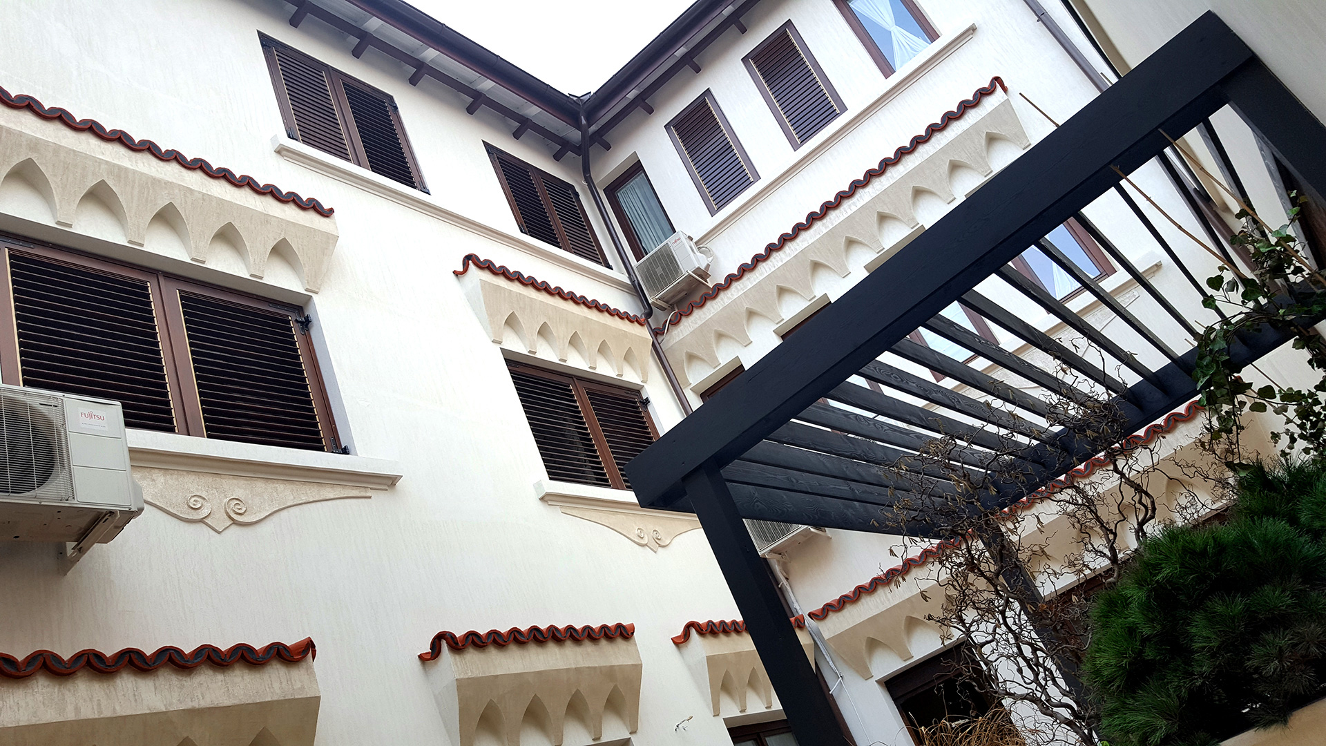 Pergola in contemporary garden with climbing plants