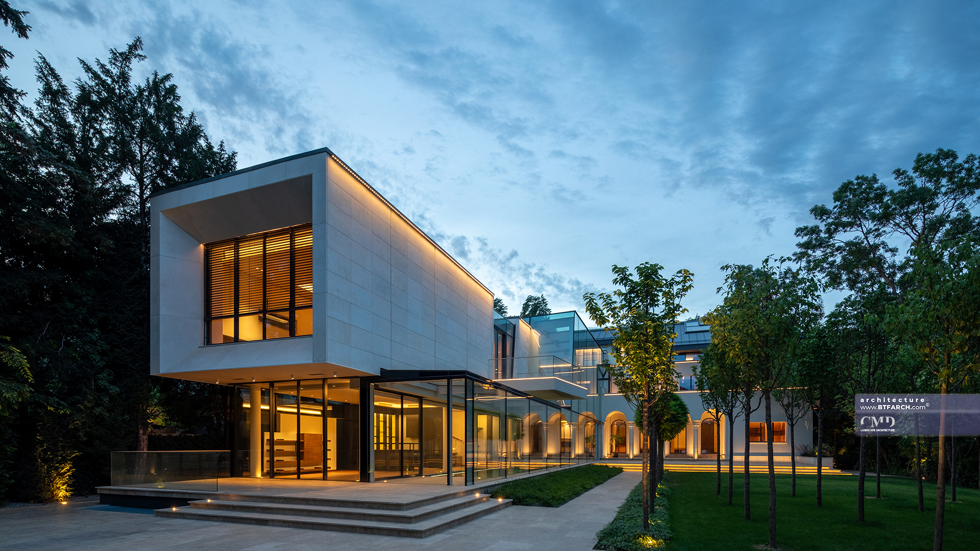 Evening view of a classical garden and contemporary house with architectural lighting and glass corridors