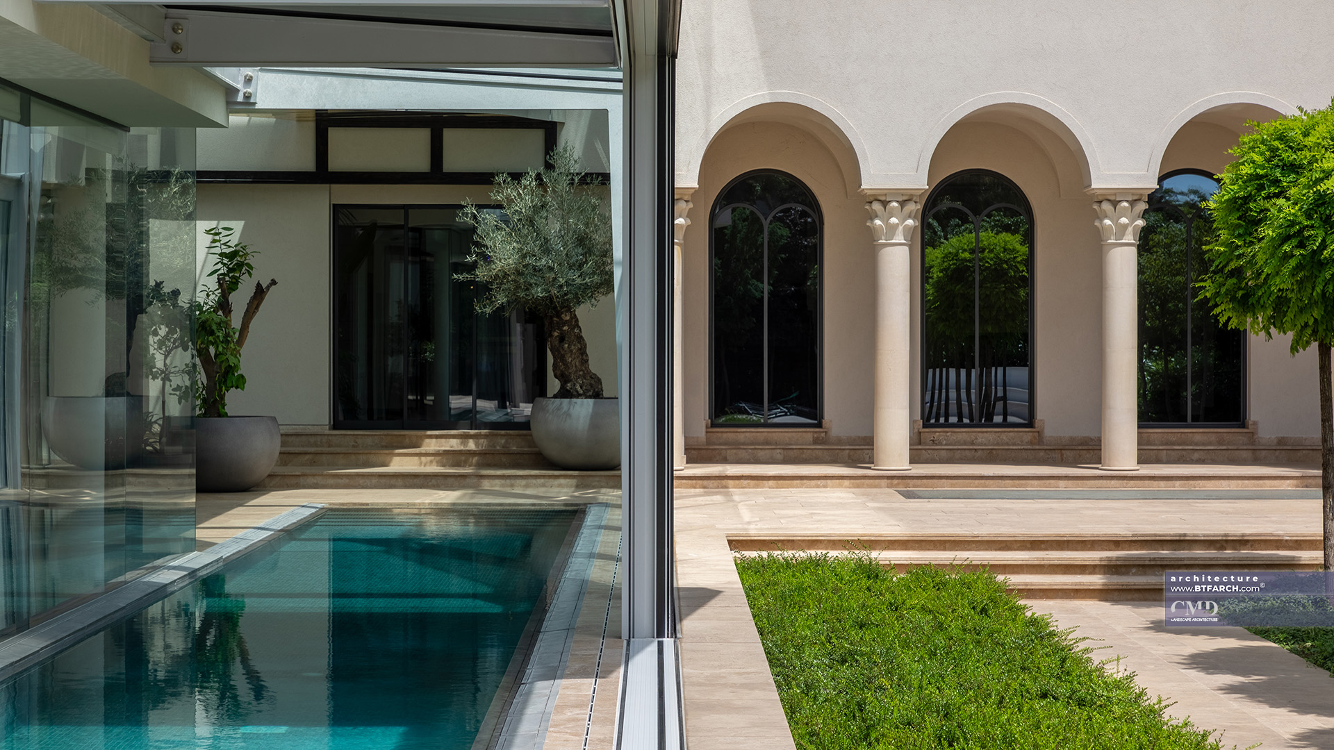 Indoor pool and Mediterranean plants inside a glass conservatory adjacent to a classical villa façade
