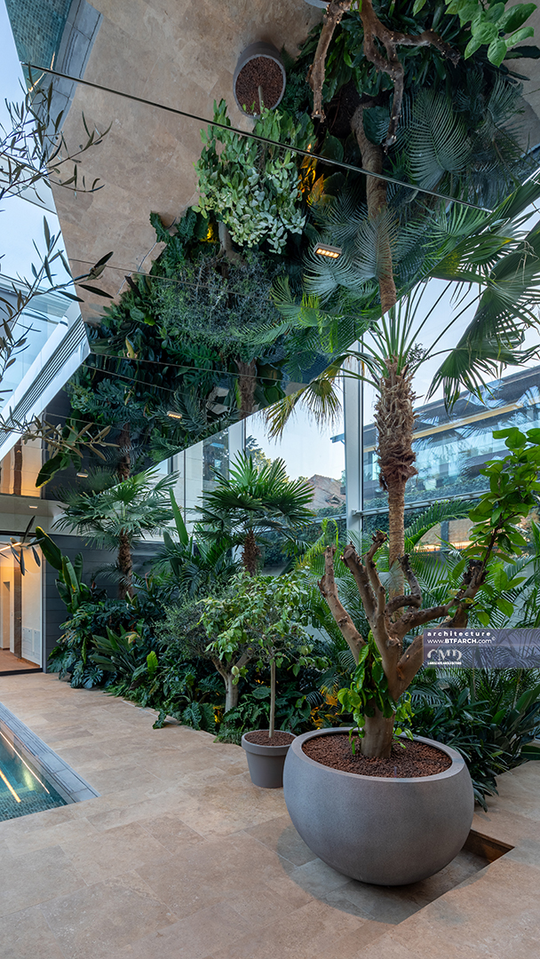 Indoor Mediterranean garden with Greek plants, mirror ceiling and lush exotic greenery next to pool area
