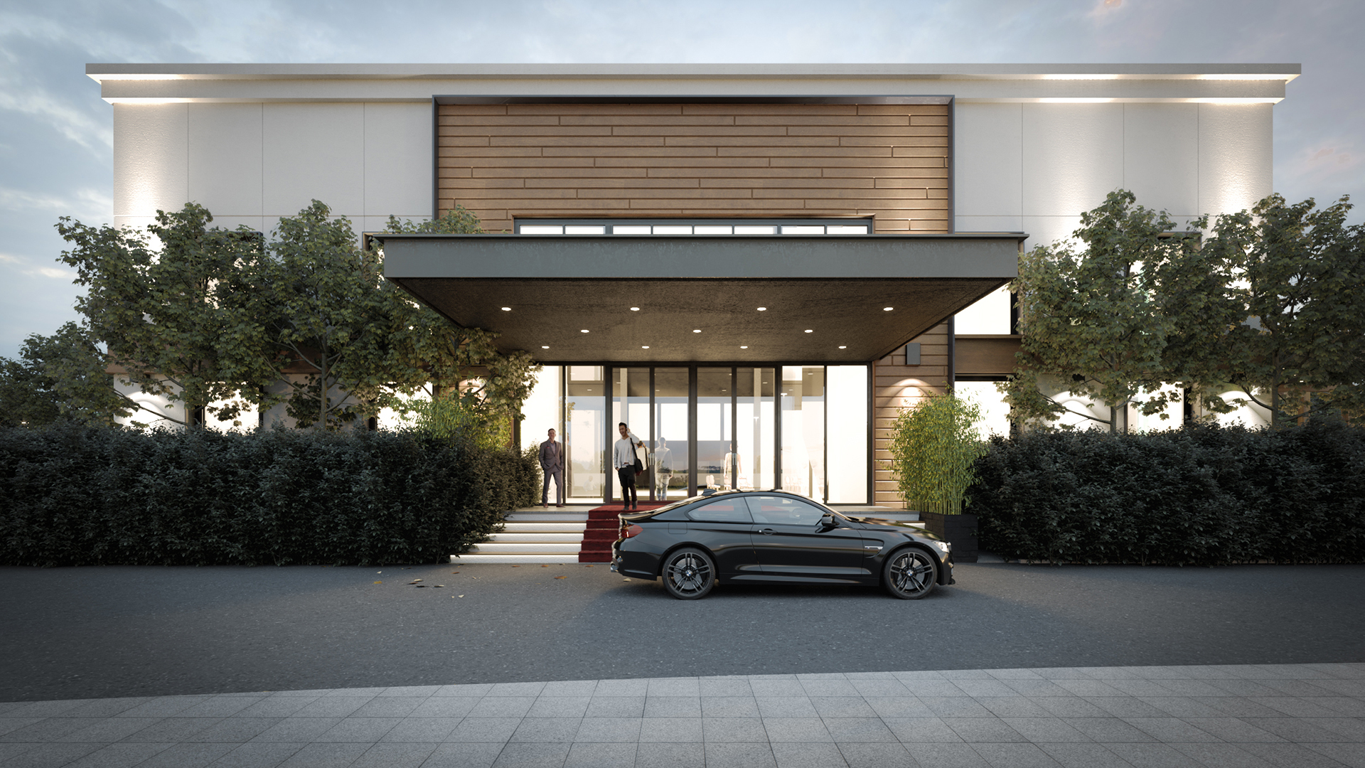 Front facade of event hall with entrance canopy, red carpet, and trees